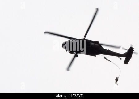 Spc. Jose Flores, a member of 1st Battalion, 503rd Airborne Infantry, 173rd Airborne Brigade, jumps from a UH-60 Black Hawk during a water entry training exercise June 24, at a Polish military training camp outside of Drawsko-Pomorskie, Poland. The 'Sky Soldiers' are in Poland at the request of the host nation to participate in combined training exercises with the 3rd Battalion, Princess Patricia's Canadian Light Infantry and Poland's 6th Airborne Brigade. (U.S. Army photo by Sgt. Eric McDonough, Oklahoma Army National Guard/Released) Paratroopers conduct water entry training 150624-Z-VF433-01 Stock Photo