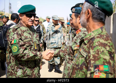 Afghan National Army (ANA) Gen. Shir Mohammad Karimi, chief of army staff, shakes hands with ANA officers, assigned to the 215th Corps, aboard Camp Shorabak, Helmand province, Afghanistan, June 27, 2014. Karimi visited with ANA leaders and ISAF advisors to discuss the military matters in the southwest region of Afghanistan. (Official U.S. Marine Corps photo by Lance Cpl. Darien J. Bjorndal, Marine Expeditionary Brigade Afghanistan/Released) Top Afghan General visits Helmand 140627-M-MF313-274 Stock Photo