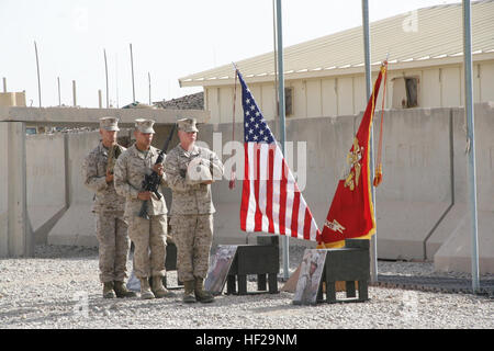 Marines with 2nd Combat Engineer Battalion carry combat boots, a rifle and Kevlar helmet to build the battlefield cross in honor of three fallen Marines during a memorial ceremony aboard Camp Leatherneck, Afghanistan, July 8, 2014. The service was held to honor Staff Sgt. David H. Stewart, a combat engineer, platoon sergeant and native of Stafford, Virginia; Cpl. Brandon J. Garabrant, a combat engineer and native of Peterborough, New Hampshire; and Cpl. Adam F. Wolff, a combat engineer and native of Cedar Rapids, Iowa, all Marines serving with 3rd Platoon, Route Clearance Company, 2nd Combat E Stock Photo