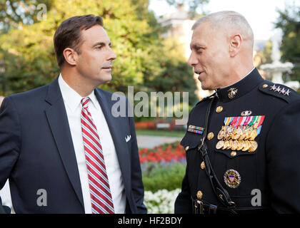 The Evening Parade host, the Assistant Commandant of the Marine Corps, Gen. John M. Paxton, Jr., right, speaks with a guest during the parade reception at the Home of the Commandants in Washington, D.C., July 25, 2014. The Evening Parades are held every Friday night during the summer months. (U.S. Marines Corps photo by Cpl. Tia Dufour/Released) Evening Parade 140725-M-KS211-008 Stock Photo