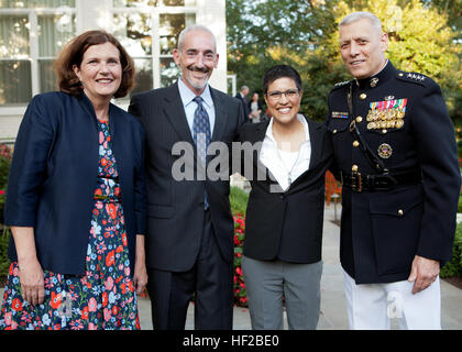 The Evening Parade host, the Assistant Commandant of the Marine Corps, Gen. John M. Paxton, Jr., right, and his wife, Debbie, left, pose for a photo with guests during the parade reception at the Home of the Commandants in Washington, D.C., July 25, 2014. The Evening Parades are held every Friday night during the summer months. (U.S. Marines Corps photo by Cpl. Tia Dufour/Released) Evening Parade 140725-M-KS211-011 Stock Photo