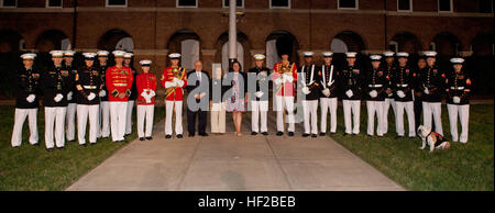 The Evening Parade guest of honor, Michigan Sen. Carl M. Levin; Barbara Levin; the parade host, Assistant Commandant of the Marine Corps, Gen. John M. Paxton, Jr.; and Debbie Paxton, pose for a photo with Marines at center walk following the parade at Marine Barracks Washington in Washington, D.C., July 25, 2014. The Evening Parades are held every Friday night during the summer months. (U.S. Marines Corps photo by Cpl. Tia Dufour/Released) Evening Parade 140725-M-KS211-073 Stock Photo