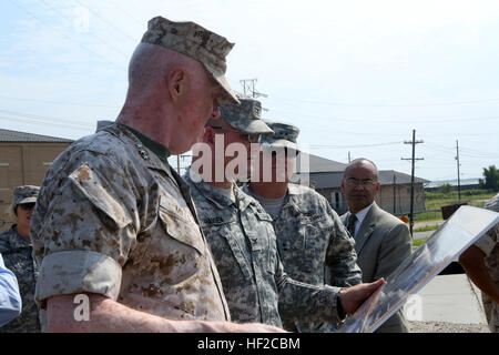 Lt. Gen. Richard P. Mills, commander of Marine Forces Reserve, looks as Col. Richard Hansen, commanding officer of the U.S. Army Corps of Engineers, shows the destruction Hurricane Katrina caused to the floodwall, along with the buildings and homes near it, Aug. 4, 2014. Mills attended a tour of the 17th Street Outfall, London Avenue Outfall Canal, Seabrook Floodgate Complex and the Jackson Barracks before attending a brief given by the Louisiana National Guard. The tour and briefs reviewed the reconstruction taking place, safety and the National Guard's response to natural disasters. Lt. Gen. Stock Photo