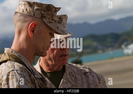 U.S. Marine Corps Gen. James F. Amos, commandant of the Marine Corps and Sgt. Maj. William T. Stables, U.S. Marine Corps Forces, Pacific, discuss the sequence of events before the U.S. Marine Corps Forces, Pacific change of command ceremony on Marine Corps Base Hawaii, August 15, 2014. Lt. Gen. John A. Toolan Jr. assumed command from Lt. Gen. Terry G. Robling during the ceremony. (U.S. Marine Corps photo by Lance Cpl. Wesley Timm/Released) MARFORPAC Change of Command Ceremony 140815-M-AR450-012 Stock Photo