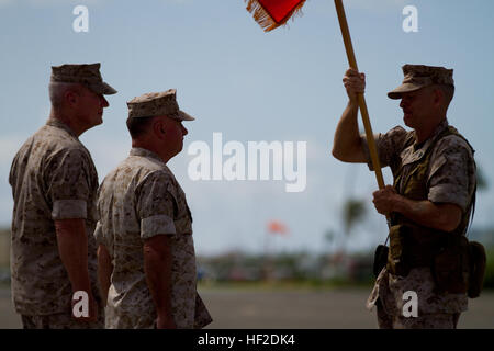 U.S. Marine Corps Sgt. Maj. William T. Stables, U.S. Marine Corps Forces, Pacific sergeant major, delivers the colors during the U.S. Marine Corps Forces, Pacific change of command ceremony on Marine Corps Base Hawaii, August 15, 2014. Lt. Gen. John A. Toolan Jr. assumed command from Lt. Gen. Terry G. Robling during the ceremony.  (U.S. Marine Corps photo by Lance Cpl. Wesley Timm/Released) MARFORPAC Change of Command Ceremony 140815-M-AR450-040 Stock Photo