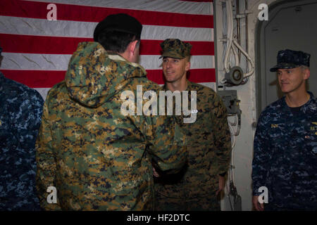 Lieutenant Col. George Hasseltine, commanding officer of Special Purpose Marine Air Ground Task Force South, and a native of Metairie, La., welcomes Division General Ricardo Martinez Menanteau, Vice Joint Chief of Staff, aboard the future amphibious assault ship USS America (LHA 6) in the Strait of Magellan, Aug. 19, 2014. American and Chilean diplomats and military officials were aboard America for a key leader engagement. The KLE consisted of a tour with several static displays showcasing the assets and capabilities SPMAGTF-South brings to the ship, a formal lunch and a leadership conference Stock Photo