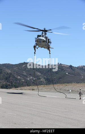 Marines perform a fast-roping exercise from a helicopter in the Pacific ...