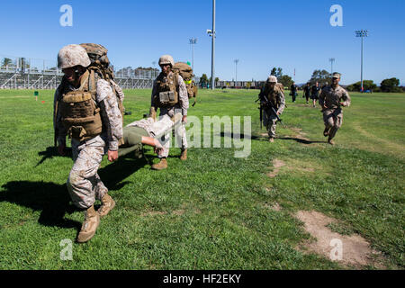 U.S. Marines with Food Service Company, Headquarters Regiment, 1st Marine Logistics Group, carry a litter with a simulated casualty during a combat conditioning course aboard Marine Corps Base Camp Pendleton, Aug. 27, 2014. The combat conditioning course is designed to improve physical and mental performance in combat conditions. (U.S. Marine Corps Photo by Cpl. Rodion Zabolotniy/Released) Headquarters Regiment combat conditioning 140827-M-HT768-074 Stock Photo