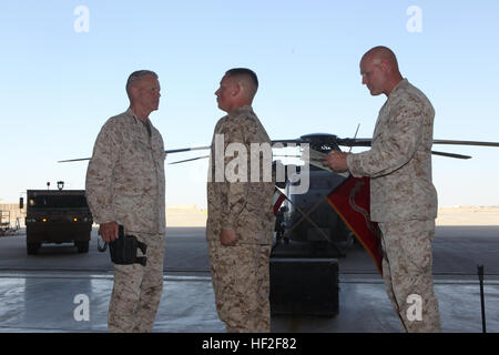 Sergeant Maj. Micheal Barrett, right, the 17th Sergeant Major of the Marine  Corps, reads the meritorious promotion warrant of Lance Cpl. Matthew Padilla, an airframe mechanic with Marine Aviation Logistics Squadron 70, Marine Aircraft Group - Afghanistan, during his meritorious promotion ceremony aboard Camp Leatherneck, Afghanistan, Sept. 6, 2014. General James F. Amos, the 35th Commandant of the Marine Corps, meritoriously promoted Padilla, a native of Littleton, Colo., to the rank of corporal during his final visit to Helmand province. Commandant, Sergeant Major of the Marine Corps visit M Stock Photo