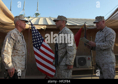 Sergeant Maj. Micheal Barrett, right, the 17th Sergeant Major of the Marine Corps, reads the meritorious promotion warrant of Corporal Dominic Sharpsteensurina, an assault section leader with Charley Company, 1st Battalion, 7th Marine Regiment, during his meritorious promotion ceremony aboard Camp Leatherneck, Afghanistan, Sept. 6, 2014. General James F. Amos, the 35th Commandant of the Marine Corps, meritoriously promoted Sharpsteensurina, a native of Minneapolis, to the rank of sergeant during his final visit to Helmand province. Commandant, Sergeant Major of the Marine Corps visit Marines,  Stock Photo