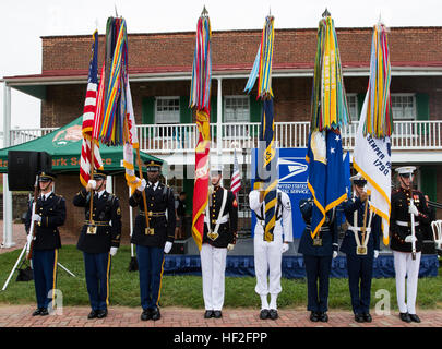 The Maryland Joint Service Color Guard presents the colors during the playing of the National Anthem at a stamp unveiling aboard Fort McHenry National Monument, Maryland, Sept. 13, 2014. The U.S. Postal Service dedicated the stamp commemorating the Battle of Fort McHenry and the 200-year anniversary of 'The Star-Spangled Banner.” The Marines in attendance were from various units, including II Marine Expeditionary Force, 1st Battalion, 10th Marine Regiment, 2nd Marine Division, and 2nd Marine Logistics Group based at Marine Corps Base Camp Lejeune, N.C., which arrived in Baltimore aboard the US Stock Photo