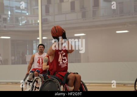 A Marine trains in wheelchair basketball practice on September 20 in preparation for the 2014 Warrior Games in Colorado Springs. The Marine team includes active duty and veteran wounded, ill and injured personnel supported by the Wounded Warrior Regiment. Stock Photo