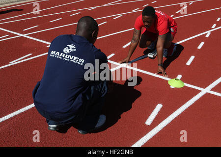 A Marine athlete receives coaching during track practice on September 24 in Colorado Springs in preparation for the 2014 Warrior Games. The Marine team, including active duty and veteran wounded, ill, and injured personnel, trains for cohesion and acclimatization to high-altitude conditions. Stock Photo