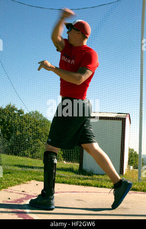 A Marine athlete practices discus throwing during field training on Sept. 25, 2014, preparing for the Warrior Games in Colorado Springs. The team, composed of active duty and veteran wounded, ill, and injured Marines, trains at high altitude above 6,000 ft. to build cohesion and competitive readiness. Stock Photo