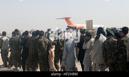 More than 100 Afghan National Army soldiers with the 215th Corps as well as Afghan civilians stand waiting to board an aircraft aboard Camp Bastion, Helmand province, Afghanistan, Sept. 27, 2014. The soldiers and civilians are planning to travel to Kabul for a rest and relaxation period with their families. (U.S. Marine Corps photo by Cpl. Cody Haas/ Released) 215th Corps soldiers conduct first Afghan-operated leave flight for rest, relaxation 140930-M-YZ032-408 Stock Photo