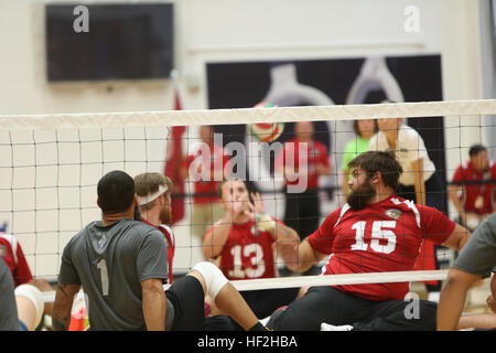 A Marine prepares to serve during sitting volleyball against USSOCOM at the 2014 Warrior Games on September 30 at the Olympic Training Center, Colorado Springs. The Marine team, composed of active duty and veteran wounded, ill, and injured Marines attached to the Wounded Warrior Regiment, trains to build team cohesion and acclimate to high-altitude conditions above 6,000 feet. Stock Photo