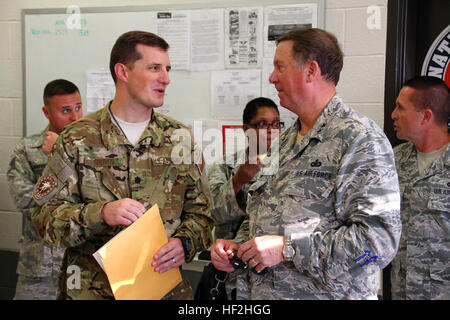 Lt. Col. Matt Groves, commander of the 123rd Contingency Response Group, speaks with Maj. Gen. Edward W. Tonini, Kentucky's adjutant general at the Kentucky Air National Guard Base in Louisville, Ky., Oct. 2, 2014. The 123rd deployed to West Africa to to set up a logistics hub in support of Operation United Assistance. (U.S. Army National Guard photo by Staff Sgt. Scott Raymond) Kentucky Guardsmen deploy to West Africa 141002-Z-GN092-031 Stock Photo