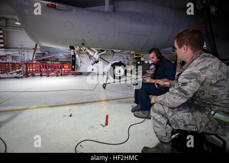 U.S. Air Force Senior Airman Jeffrey Montemurro, left, goes over technical orders as Airman 1st Class Jonathan Enos looks on during wheel lift testing of an F-16C Fighting Falcon from the New Jersey Air National Guard's 177th Fighter Wing 'Jersey Devils' at Atlantic City Air National Guard Base, N.J., Oct. 2, 2014. Montemurro and Enos are both crew chiefs with the 177th Aircraft Maintenance Squadron. (U.S. Air National Guard photo by Tech. Sgt. Matt Hecht/Released) Wheels up 141002-Z-NI803-013 Stock Photo