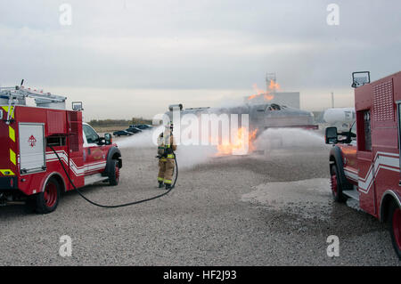 Scott R. Fitzhugh, a firefighter at Buckley Air Force Bas, assists in extinguishing a staged aircraft fire during a Major Accident Response Exercise. Members from the Colorado Air National Guard and the 460th Space Wing joined forces on Buckley Air Force Base to conduct a MARE training event. The exercise scenario was based on a simulated aircraft crash on base and evaluated the response efforts from the base fire department, hazmat clean-up team, security forces, as well as many others. MARE exercise 141009-Z-QD622-055 Stock Photo