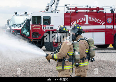 Firefighters from Buckley Air Force Base hose down a simulated aircraft wreckage during a Major Accident Response Exercise on base. Members from the Colorado Air National Guard and the 460th Space Wing joined forces on Buckley Air Force Base to conduct a MARE training event. The exercise scenario was based on a simulated aircraft crash on base and evaluated the response efforts from the base fire department, hazmat clean-up team, security forces, as well as many others. MARE exercise 141009-Z-QD622-180 Stock Photo