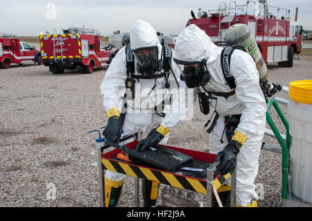 Hazmat team members Staff Sgt. Don Carson and Tech Sgt. Casey Peterson from the 140th Wing, Colorado Air National Guard double check their procedures in an effort to clean up a simulated hydrazine  spill during a Major Accident Response Exercise on Buckley Air Force Base. Members from the Colorado Air National Guard and the 460th Space Wing joined forces on Buckley Air Force Base to conduct a MARE training event. The exercise scenario was based on a simulated aircraft crash on base and evaluated the response efforts from the base fire department, hazmat clean-up team, security forces, as well  Stock Photo