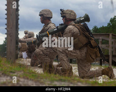 A marine with 2nd Battalion, 8th Marine Regiment, 2nd Marine Division, looks downrange before firing an AT-4 anti-tank weapon during a live-fire exercise aboard Marine Corps Base Camp Lejeune, N.C., Oct. 16, 2014. The Marines also fired the M72 light anti-armor weapon and the MK-153 shoulder-launched multipurpose assault weapon systems during a two-day exercise. (U.S. Marine Corps photo by Lance Cpl. Lucas J. Hopkins/Released) 2-8 fire rockets during live-fire exercise 141016-M-TR086-133 Stock Photo