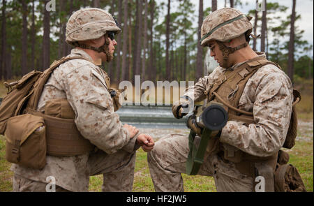 Marines with 2nd Battalion, 8th Marine Regiment, 2nd Marine Division, perform a functions check on an AT-4 anti-tank weapon during a live-fire exercise aboard Marine Corps Base Camp Lejeune, N.C., Oct. 16, 2014. The two-day exercise tested the Marines’ capabilities with the AT-4, the M72 light anti-armor weapon and the MK-153 shoulder-launched multipurpose assault weapon systems. (U.S. Marine Corps photo by Lance Cpl. Lucas J. Hopkins/Released) 2-8 fire rockets during live-fire exercise 141016-M-TR086-339 Stock Photo