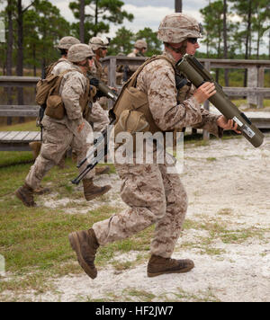 Marines with 2nd Battalion, 8th Marine Regiment, 2nd Marine Division, run toward a firing line during a live-fire exercise aboard Marine Corps Base Camp Lejeune, N.C., Oct. 16, 2014. The training tested the Marines’ capabilities with the AT-4, the M72 light anti-armor weapon and the MK-153 shoulder-launched multipurpose assault weapon systems. (U.S. Marine Corps photo by Lance Cpl. Lucas J. Hopkins/Released) 2-8 fire rockets during live-fire exercise 141016-M-TR086-407 Stock Photo