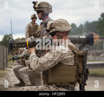 A Marine with 2nd Battalion, 8th Marine Regiment, 2nd Marine Division, fires an AT-4 anti-tank weapon during a live-fire exercise aboard Marine Corps Base Camp Lejeune, N.C., Oct. 16, 2014. The training helped promote unit cohesion and efficiency while also preparing the Marines for an upcoming deployment with the Black Sea Rotational Force. (U.S. Marine Corps photo by Lance Cpl. Lucas J. Hopkins/Released) 2-8 fire rockets during live-fire exercise 141016-M-TR086-517 Stock Photo