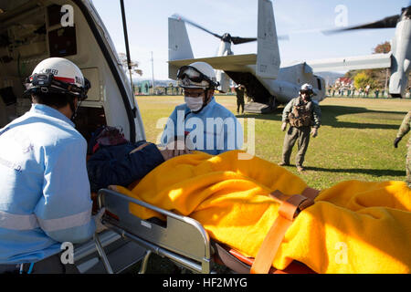 Emergency medical technicians with the Oshima Fire Department transfer a notionally wounded victim to an MV-22B Osprey tiltrotor aircraft Nov. 8 during Tomodachi relief exercise 15.2 near Izu Oshima Island, Tokyo Metropolis Prefecture, Japan. TREX 15.2 is an annual, bilateral training exercise that simulates humanitarian assistance and disaster relief missions in Japan while strengthening the U.S. and Japanese alliance. In less than eight minutes, more than 600 pounds of relief supplies were offloaded from an Osprey so two notionally wounded victims could evacuated. (U.S. Marine Corps photo by