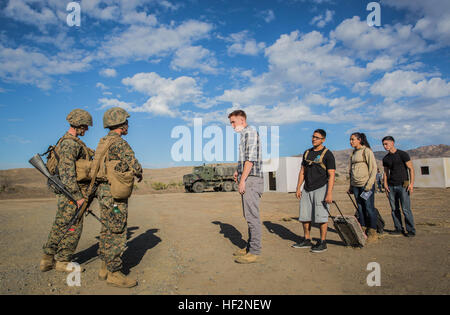 U.S. Marines with Combat Logistics Battalion 15, 15th Marine Expeditionary Unit, receive role players acting as American citizens at an evacuation control center during non-combatant evacuation operation training aboard Camp Pendleton, Calif., Nov. 19, 2014. The training is designed to improve Marines’ tactics in assisting the Department of State in evacuating U.S. citizens and civilian personnel from foreign nations to an appropriate safe haven. (U.S. Marine Corps photo by Sgt. Emmanuel Ramos/Released) 15th MEU Marines train for noncombatant evacuation operations 141119-M-ST621-048 Stock Photo