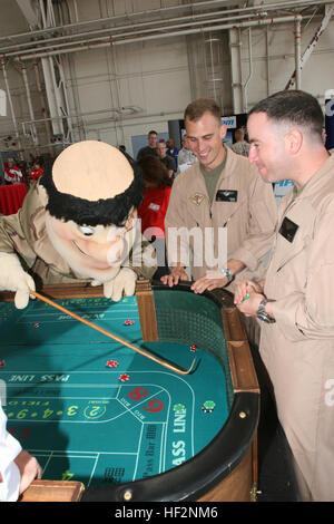 MARINE CORPS AIR STATION MIRAMAR Calif., -The San Diego Padres mascot Friar John plays a game of craps with Marines during the welcome home party inside Hangar 1 aboard Marine Corps Air Station Miramar, March 13. Throughout the afternoon, Marines and sailors played poker, shook hands with celebrities and listened to live music. (U.S. Marine Corps photo by Lance Cpl. Christopher O'Quin) (Released) USMC-090313-M-2708O-177 Stock Photo
