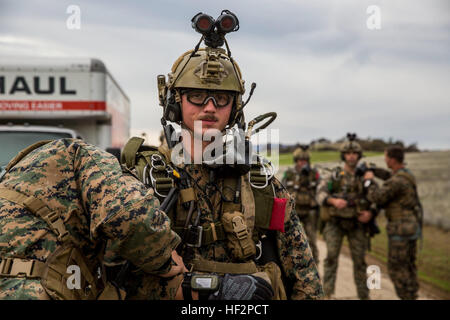 U.S. Marine Sgt. Nathaniel Houck stands while his gear is checked prior to a static-line jump during realistic urban training aboard Fort Hunter Liggett, Calif., Dec. 9, 2014. Houck is part of the 15th Marine Expeditionary Unit’s Force Reconnaissance Detachment. The purpose of RUT is to provide the MEU an opportunity to conduct training in unfamiliar environments in preparation for their upcoming deployment. (U.S. Marine Corps photo by Cpl. Anna Albrecht/Released) 15th MEU Marines conduct static line jumps 141209-M-SV584-082 Stock Photo