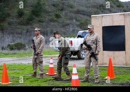 Marine 1st Lt. David Deal, platoon commander, Company A, 1st Battalion, 5th Marine Regiment, 1st Marine Division, reacts to the heating sensation of the Active Denial System during a demonstration aboard Camp Pendleton, Calif., Dec. 17, 2014. The system is a non-lethal weapon that uses millimeter wave technology to give the effect of an almost intolerable heating sensation, but causes no damage to the body. Three non-lethal weapon systems are demonstrated aboard Camp Pendleton during Exercise Valiant Mark 141217-M-SE196-8961 Stock Photo