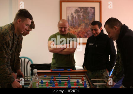 Black Sea Rotational Force Marines and Bulgarian soldiers play a friendly game of foosball against each other during a break in their classes on Jan. 13. The Marines are currently on exercise Platinum Lion 15 at Novo Selo Training Area, Bulgaria, working with Bulgarian, Serbian and Romanian armed forces. (U.S. Marine Corps photo by Cpl. Ryan Young/ released) Platinum Lion 15 roars to life in Bulgaria 150112-M-KK554-208 Stock Photo