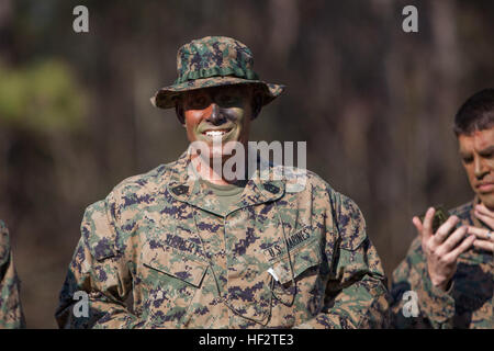 U.S. Marines Corps 1st Sgt. Shawn M. Hebert, Instructor Training Company First Sergeant, Advanced Infantry Training Battalion, School of Infantry-East stands by after applying camouflage face paint before an 800m stalk on Camp Lejeune, NC, Jan. 21, 2015. Officers and Staff NCOs underwent training normally taught to snipers that required each Marine to advance 800 meters, set up, and identify a target all while remaining undetected. (U.S. Marine Corps photo by SOI-East Combat Camera, Lance Cpl. Andrew Kuppers/ Released) School of Infantry Officers and Staff NCOs undergo Scout Sniper Training 15 Stock Photo