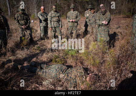 U.S. Marines with the School of Infantry-East receive a class on camouflage before executing an 800m stalk on Camp Lejeune, NC, Jan. 21, 2015. Officers and Staff NCOs underwent training normally taught to snipers that required each Marine to advance 800 meters, set up, and identify a target all while remaining undetected. (U.S. Marine Corps photo by SOI-East Combat Camera, Lance Cpl. Andrew Kuppers/ Released) School of Infantry Officers and Staff NCOs undergo Scout Sniper Training 150121-M-NT768-016 Stock Photo