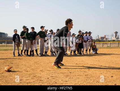 Keiichi Hirano, a Japanese major league baseball player, pitches to an