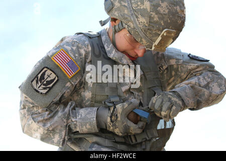 U.S. Soldier Sgt. Lauren Rhodes, 59th Aviation Troop Command, South Carolina Army National Guard, pulls the pin on a training grenade during the urban operations section of the Best Warrior Competition held Jan. 30-Feb. 3, 2015, at the McCrady Training Center on Fort Jackson, Eastover, S.C. Soldiers from across South Carolina competed against one another in a variety of physical, mental and technical skills to decide who will represent the state at the regional level. (U.S. Army National Guard photo by Sgt. Brad Mincey/Released) South CarolinaE28099s Best Warriors compete for top honors 150131 Stock Photo