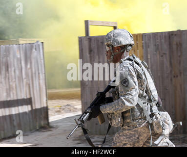 U.S. Soldier Pfc. Malcolm Brown, 59th Troop Command, South Carolina Army National Guard, runs trough the urban operations section of the Best Warrior Competition Jan. 30-Feb. 3, 2015, where Soldiers had to react to enemy targets, smoke other obstacles. Soldiers from across South Carolina compete against one another at the McCrady Training Center on Fort Jackson, Eastover, S.C., in a variety of physical, mental and technical skills to decide who will represent the state at the regional level. (U.S. Army National Guard photo by  Sgt. Brad Mincey/Released) South CarolinaE28099s Best Warriors comp Stock Photo