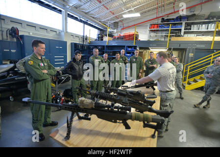 A pararescue jumper from the 103rd Rescue Squadron of the New York Air National Guard's 106th Rescue Wing demonstrates equipment to  aircrew and rescue swimmers from United States Coast Guard's  Air Station Elizabeth City, N.C., at Gabreski Air National Guard Base, Westhampton Beach, N.Y., Feb. 5, 2015. The Coast Guardsmen and Air Guard members met  to discuss possible joint training, compare rescue tactics and showcase squadron equipment and training. (U.S. Air National Staff Sergeant Christopher S Muncy / released) 103rd Rescue Squadron meets with Coast Guardsmen from Air Station Elizabeth C Stock Photo