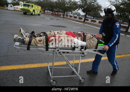 Justin Van Damme, flight paramedic, Meducare Air, Charleston, South Carolina, pushes the victim U.S. Marine Staff Sgt. Christopher Del Valle, drill instructor, Delta Company, 1st Recruit Training Battalion, Recruit Training Regiment, Marine Corps Recruit Depot Parris Island, after being effected by a vehicle borne explosive device during a simulated terrorist attack for the Anti-Terrorism/Force Protection Exercise aboard Marine Corps Recruit Depot Parris Island, S.C., Feb. 5, 2015. The simulated attack was held to test the actions and reaction times of the first responders as well as the Marin Stock Photo