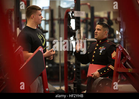 Shane Lemieux (left), a senior at West Valley High School in Yakima, Washington, speaks with local Marine recruiter Sgt. James Campos prior to receiving a Semper Fidelis All-American Bowl game certificate in the school's weight room Feb. 18, 2015. Lemieux, a highly-touted offensive guard, was one of three Washington State football players selected to play in the January 4 game in Carson, California. Following his high school graduation, Lemieux will attend the University of Oregon on an athletic scholarship. (U.S. Marine Corps photo by Sgt. Reece Lodder) Yakima Marines recognize West Valley Hi Stock Photo