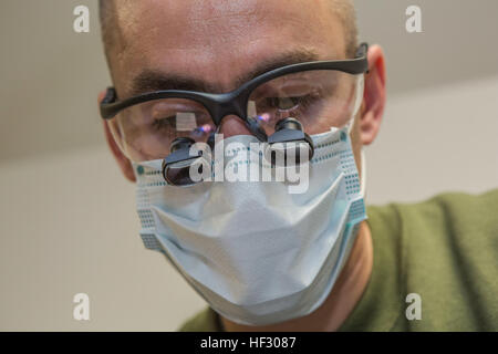 U.S. Navy Lieutenant Dustin A. Bond, with 22nd Dental Company, 2nd Dental Battalion (2nd Den Bn), 2nd Marine Logistics Group (2nd MLG) performs an oral cleaning at Quantico, Virginia, Feb. 24, 2015. 2nd Den Bn provided support to 1st Battalion, 8th Marine Regiment, 2nd Marine Division, and 2nd Transportation Support Battalion, 2nd MLG during a Deployment For Training (DFT) exercise. (U.S. Marine Corps photo by Cpl. Desire M. Mora/ Released) US Marines receive dental treatment during Deployment For Training exercise 150224-M-TG562-041 Stock Photo