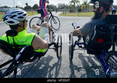 Army Sergeant 1st Class Andrew Gonzales (left) and retired Army Staff Sgt. Victor Sassoon (right), both members of the U.S. Special Operations Command (USSOCOM) Military Adaptive Sports Program (MASP) team, rest prior to another round of cycling at MacDill Air Force Base, Fla., Feb 25.  Veteran and active duty Special Operations Forces participated in archery, track and field, swimming and shooting competitions. This training camp was designed to introduce participants to new sports as well as hone skills in preparation for upcoming Defense Department sporting events. Military Adaptive Sports  Stock Photo