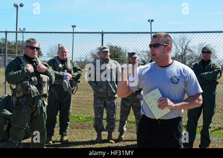 First responders from Georgetown emergency services along with U.S. Army UH-60 Black Hawk helicopter crews assigned to the 2-151st Aviation, S.C. Army National Guard, are gathered around the South Carolina Helicopter Aquatic Rescue Team (SC-HART) civilian commander, Dan McManus, for a safety brief during the Vigilant Guard South Carolina exercise, in Georgetown, S.C., March 7, 2015. Vigilant Guard is a series of federally funded disaster-response drills conducted by National Guard units working with federal, state and local emergency management agencies and first responders. (U.S. Air National Stock Photo