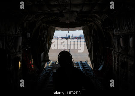 U.S. Marine Corps Staff Sgt. Franklin E. Butterfield, a load master instructor assigned to Marine Aerial Refueler Transport Squadron (VMGR) 252, opens a cargo door during a Flight In Support of a Deployed Unit (FISDU) at Moron Air Field, Spain, March 10, 2015. The FISDU was conducted to support Marines assigned to Special Purpose Marine Air Ground Task Force conducting operations in foreign countries. (U.S. Marine Corps photo by Lance Cpl. Koby I. Saunders/Released) VMGR-252 Flight In Support of A Deployed Unit 150310-M-AF202-029 Stock Photo