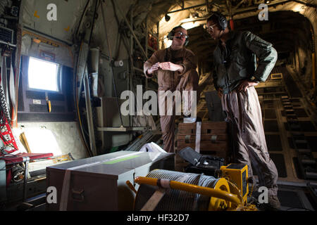 U.S. Marine Corps Staff Sgt. Franklin E. Butterfield, a load master instructor, and Cpl. Collin Q. Gates, a crew master, both assigned to Marine Aerial Refueler Transport Squadron (VMGR) 252, discuss the arrangement of incoming cargo during a Flight In Support of a Deployed Unit (FISDU) at Moron Air Field, Spain, March 10, 2015. The FISDU was conducted to support Marines assigned to Special Purpose Marine Air Ground Task Force conducting operations in foreign countries. (U.S. Marine Corps photo by Lance Cpl. Koby I. Saunders/Released) VMGR-252 Flight In Support of A Deployed Unit 150310-M-AF20 Stock Photo