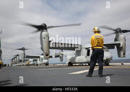 A U.S. Navy Aviation Boatswain’s Mate waits as MV-22B Ospreys prepare to take off from the flight deck of the USS Bonhomme Richard (LHD 6), at sea, March 13, 2015. The Ospreys are transporting U.S. Marines for an airfield seizure training operation. The Ospreys are with Marine Medium Tiltrotor Squadron 262 (Reinforced), 31st Marine Expeditionary Unit (MEU). The Marines of the 31st MEU are currently on their annually-scheduled Spring Patrol of the Asia-Pacific region. (U.S. Marine Corps photo by Lance Cpl. Ryan Mains/released) Eight Ospreys take off from USS Bonhomme Richard 150313-M-WM612-063