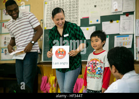 Sgt. Desiree Guerrero and Lance Cpl. Michael Webb teach English at the Play in English Program March 18 at Suginoko Preschool in Kin Town, Okinawa. The children learned to say the Marines names and phrases like “I’m hungry” and “I’m angry.” At the end of the program, students received a certificate of completion. Guerrero is intelligence specialist from San Antonio, Texas. Webb is also an intelligence specialist from Zachary, Louisiana. The Marines are with 3rd Intelligence Battalion, III Marine Expeditionary Force Headquarters Group, III MEF. (U.S. Marine Corps photo by Cpl. Rebecca Elmy/Rele Stock Photo